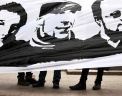 Участники пикета на Чистопрудном бульваре держат плакат с портретами задержанных по делу о беспорядках на Манежной площади в Москве в декабре 2010 года. Беспорядки были вызваны убийством футбольного фаната Егора Свиридова. Фото: РИА Новости